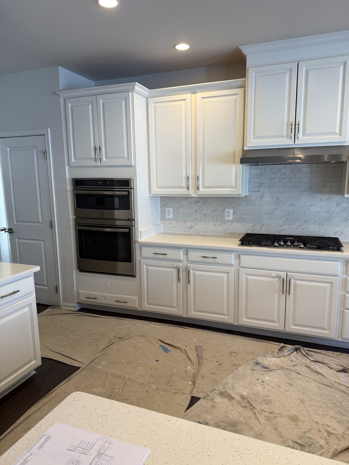 White kitchen double wall oven and cabinetry