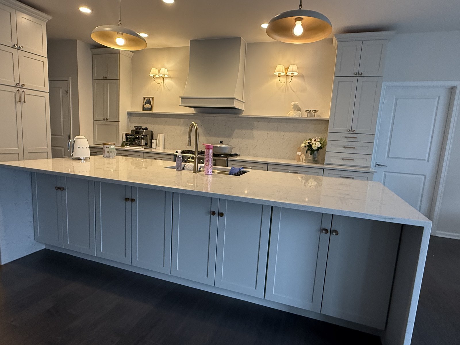 Elegant gray kitchen with large island and pendant lights